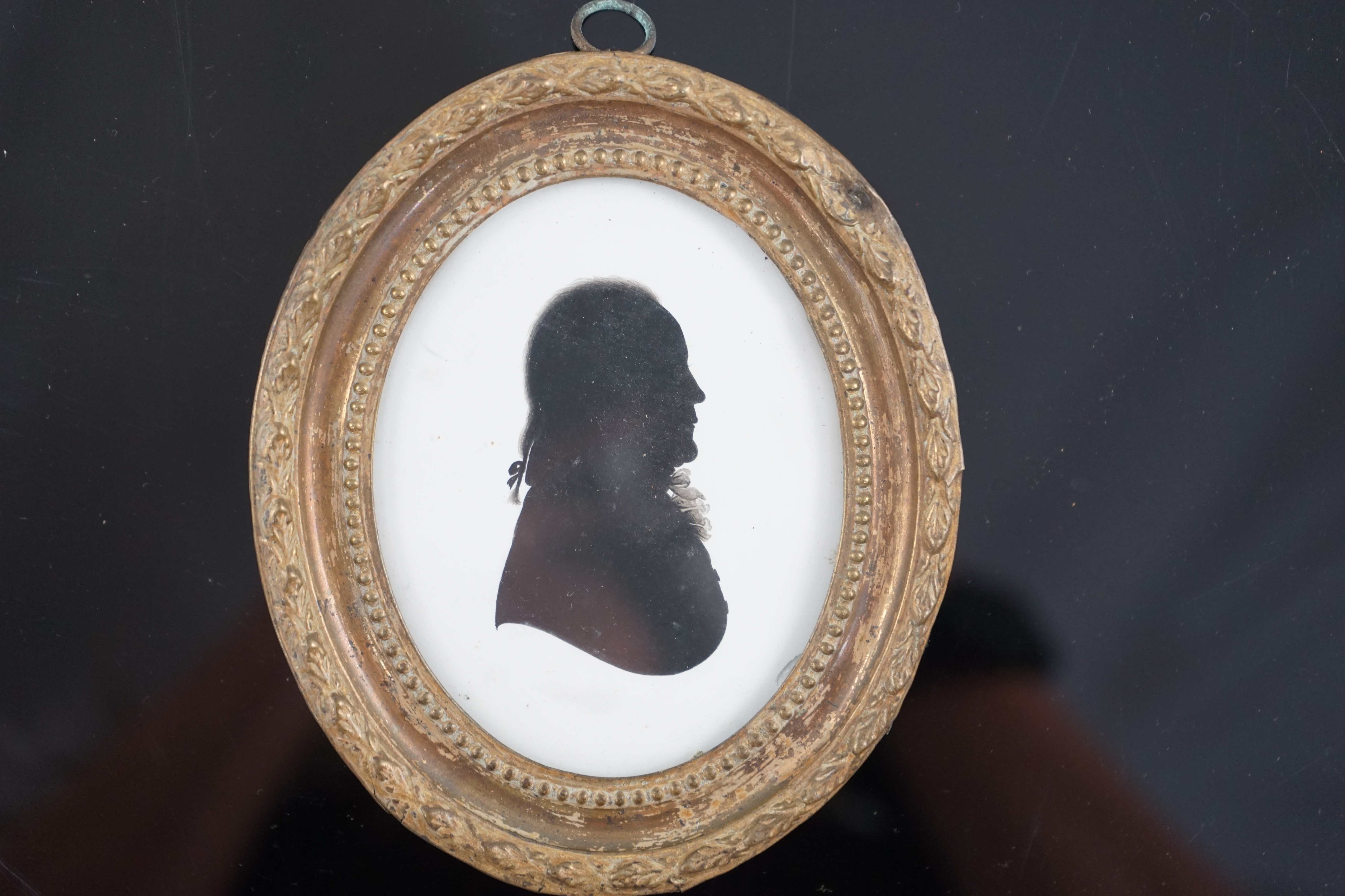 John Miers (1756-1821), Silhouette of a gentleman, painted plaster, 8.7 x 6.7cm.